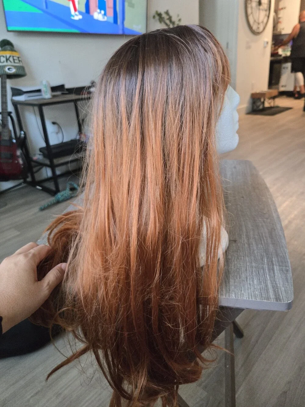 long auburn wig with dark brown roots and face-framing wispy bangs Sunthetic